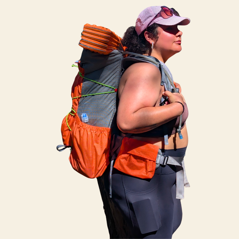Plus-size hiker wearing the Sojurnr Resolute 50-55 women’s backpack with an adjustable torso and expandable hipbelt.